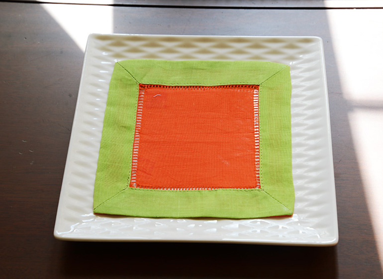 hemstitch cocktail napkin, hot orange with hot green color border.
